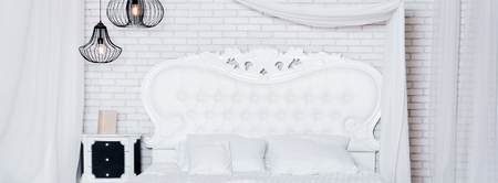 King size bed in loft apartment. Loft style bedroom with white designの写真素材