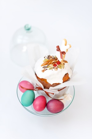 Easter cake and painted eggs. Easter composition with orthodox sweet bread, kulich and eggs on light...