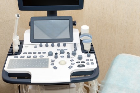 Interior of examination room with ultrasonography machine in hospital laboratory. Modern medical equipment background.の写真素材