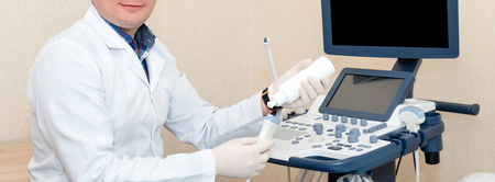 Doctor performing ultrasound scan in clinic. Expecting of child and diagnosing with ultrasound. Long bannerの写真素材