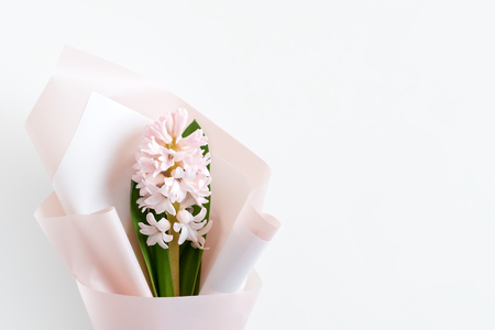 Spring flowers. Fresh bouquet with hyacinth in minimal style on light background. Top view, spring flat lay with copyspace for text. Love and gift conceptの写真素材