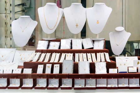 Jewelry diamond rings and necklaces show in luxury retail store window display showcaseの写真素材