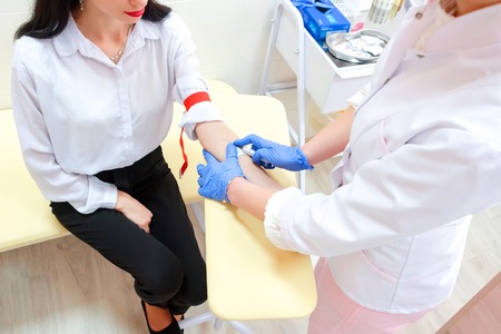 Preparation for blood test. Medical technician preparing before taking a blood sample from patient.の写真素材