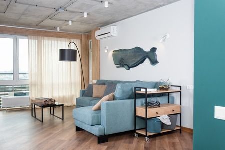 Minimalist modern living room with sofa in loft style flat. Modern loft with a kitchen and living...