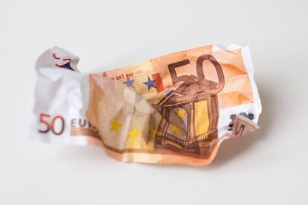 Crumpled euro money. European currency bills of 50 euros on white background. Selective focus. Money...