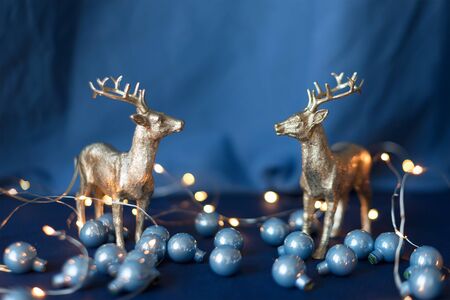 Christmas reindeers with Christmas lights and decorations. Beautiful golden reindeer toys, Santa helpers decoration, Christmas tree bauble. New Year conceptの写真素材