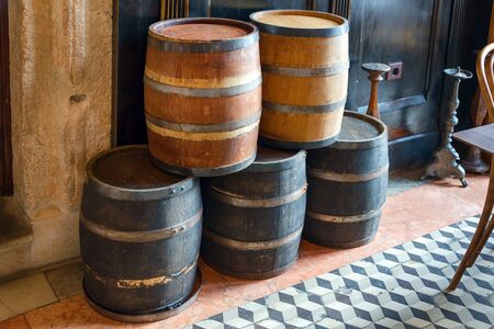 Oak barrels for storing wine, liquor and beer. Old wooden barrel with rusty hoops in pub, bar...