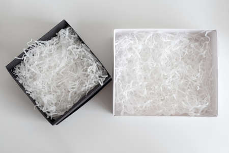 Opened gift boxes with decorative straw, filler, shavings. paper box for your product placement or...