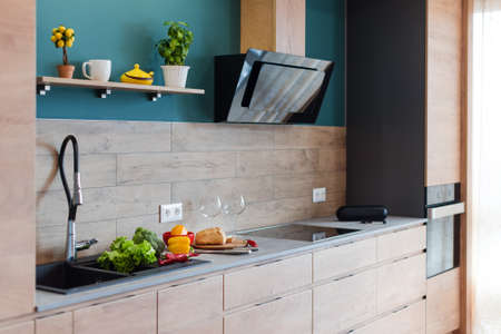 Modern furniture in luxury kitchen. Minimalist scandinavian interior in loft apartment with wooden...