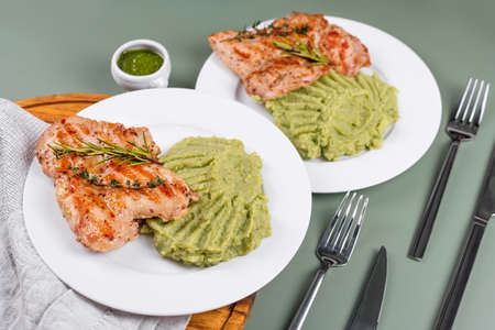 Delicious grilled chicken with herbs and green puree. Chicken fillet with mashed potatoes, green...