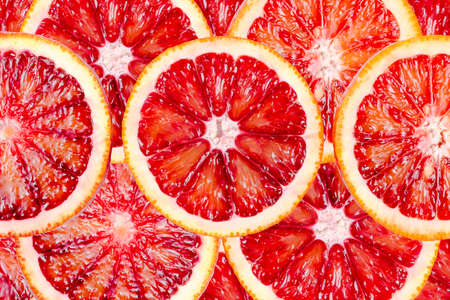 Sliced bloody oranges texture. Fresh ripe red sicilian orange, citrus fruit for background.の写真素材