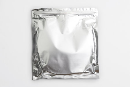 Foil bag package isolated on white background. Silver aluminium metallic foil doypack, packaging pouch with zipperの写真素材
