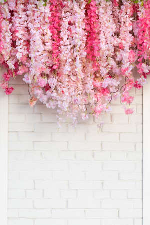 Flower texture background for wedding scene. Flowers on white brick wall with free space for text. Wedding or party decoration. Floral arrangement, floristics settingの写真素材