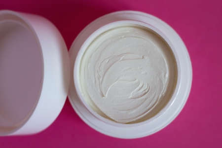 Cosmetic cream on pink background. Beauty and skin care themeの写真素材