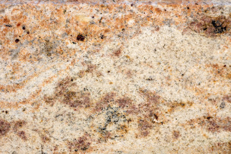 Granite texture, granite slab background, yellow marble stone. Decorative element of old building...