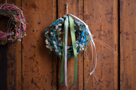 Beautiful hand made everlasting dry wreath made of willow branches, wheat and colorful ribbons on...
