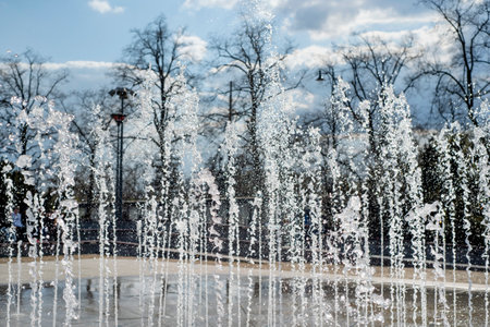 Fountain in the street. Water jets in sunny day, splashing fountain. Selective focusの写真素材