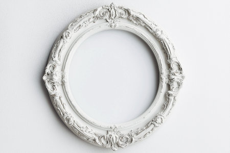 Baroque round ornate frame with an elegant flower motif background. A detailed white vintage round frame with floral ornamentation on white background. Mockup with copy space for text.の素材