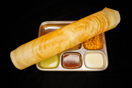 Pancakes in a box with different sauces on a black backgroundの写真素材