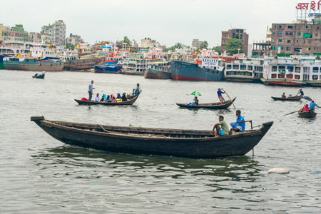 Unidentified people are rowing a boat in Sadar Ghatの写真素材