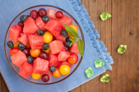 Fruit and berry salad of watermelon, blueberries, plums, currants, gooseberry cherry plumの写真素材