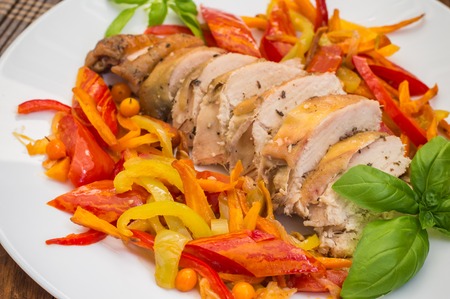 Roast duck breast with vegetable saute on a plate.の写真素材