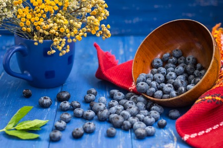 Crumble with blueberries basket on the table. Wooden backgroundの写真素材