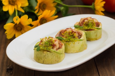 Courgettes stuffed with tomatoes, minced meat, cheese and spices. Wooden backgroundの写真素材