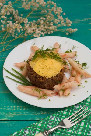 Meat casserole, Italian pasta and cheese crisps. Wooden backgroundの写真素材