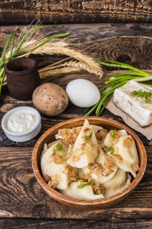 Boiled dumplings with potatoes. Wooden backgroundの写真素材
