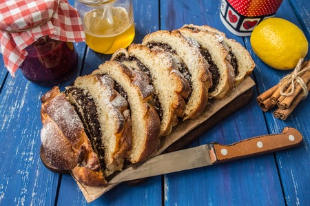 Poppy seed Roll on a wooden blue backgroundの写真素材