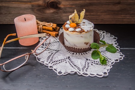Cake with cream on a dark wood background.の写真素材