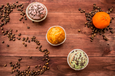 Cupcakes with coffee beans on the tableの写真素材