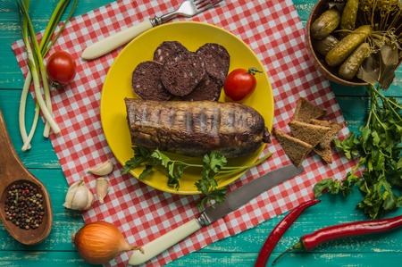 Homemade blood sausage with offal on a turquoise wooden background. top viewの写真素材