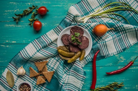Homemade blood sausage with offal on a turquoise wooden background. top viewの写真素材