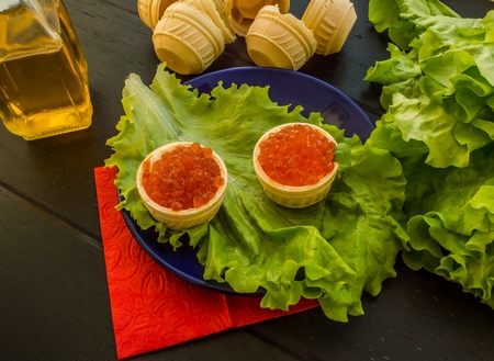 Salmon red caviar and lettuce leaves. Close-upの写真素材