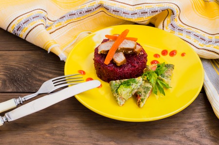 Tasty and fresh dinner with stewed beets, roasted meat, carrots and Spanish omelette. Wooden table. Top view. Close-upの写真素材