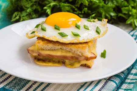 Croque-Madame, a French sandwich with greens and berry juice for breakfast. Wooden table. Top viewの写真素材