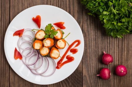 Rolls saute carrots, cream cheese, garlic and mayonnaise. wood backgroundの写真素材