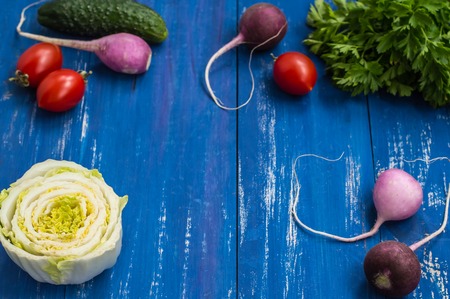 Set of vegetables on a wooden blue background. Close-upの写真素材