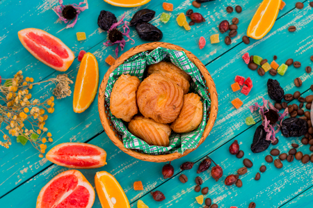 Custard pastries with coffee and sweets with different fruits. Cute and fabulous breakfast. Turquoise wooden background.の写真素材