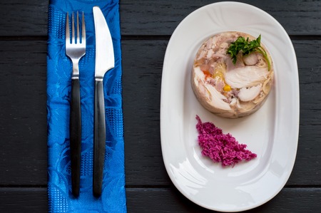 Aspic with meat and horseradish on a wooden table. Top view. Close-upの写真素材