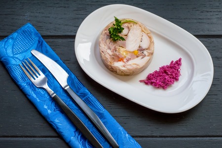 Aspic with meat and horseradish on a wooden table. Top view. Close-upの写真素材