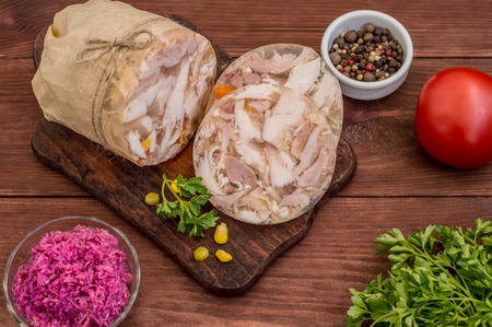 Aspic with meat and horseradish on a wooden table