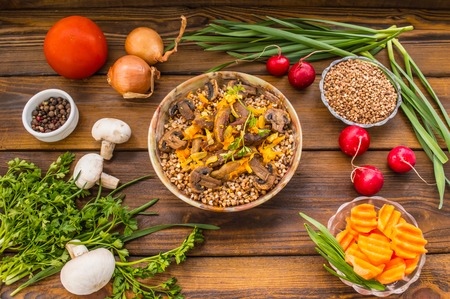 Buckwheat porridge with meat and mushrooms on wooden rustic background. Top view. Close-upの写真素材