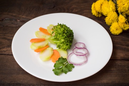 Broccoli zucchini, carrots, onions blue al dente. Wooden background. Top view. Close-upの写真素材