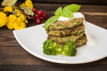 Broccoli and spinach pancakes with yogurt dressing  fresh herbs.の写真素材