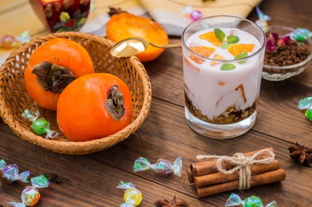 freshness cut fruit, persimmon on honey yogurtの写真素材