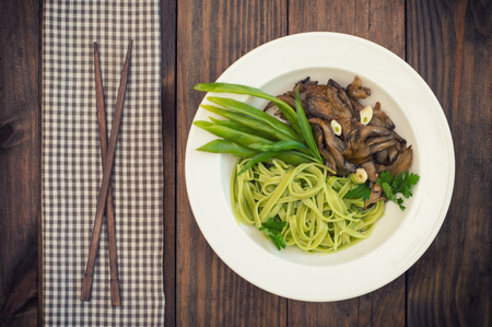 Plate of spaghetti dough with spinach and oyster mushrooms. Italian cuisine, Italian recipesの写真素材