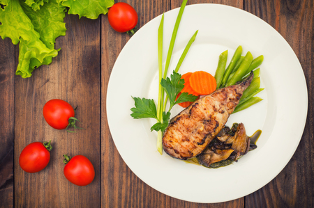 Tasty baked fish on plate on table close-upの写真素材